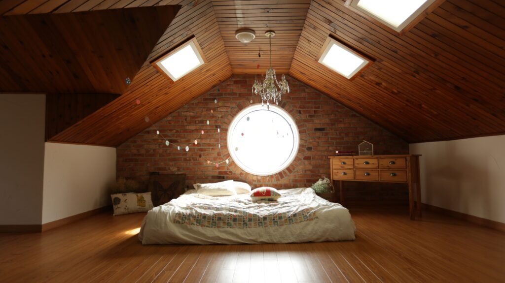 pexels-photo-271743-271743 A warm and inviting attic bedroom featuring a unique brick wall and wooden ceiling design.
