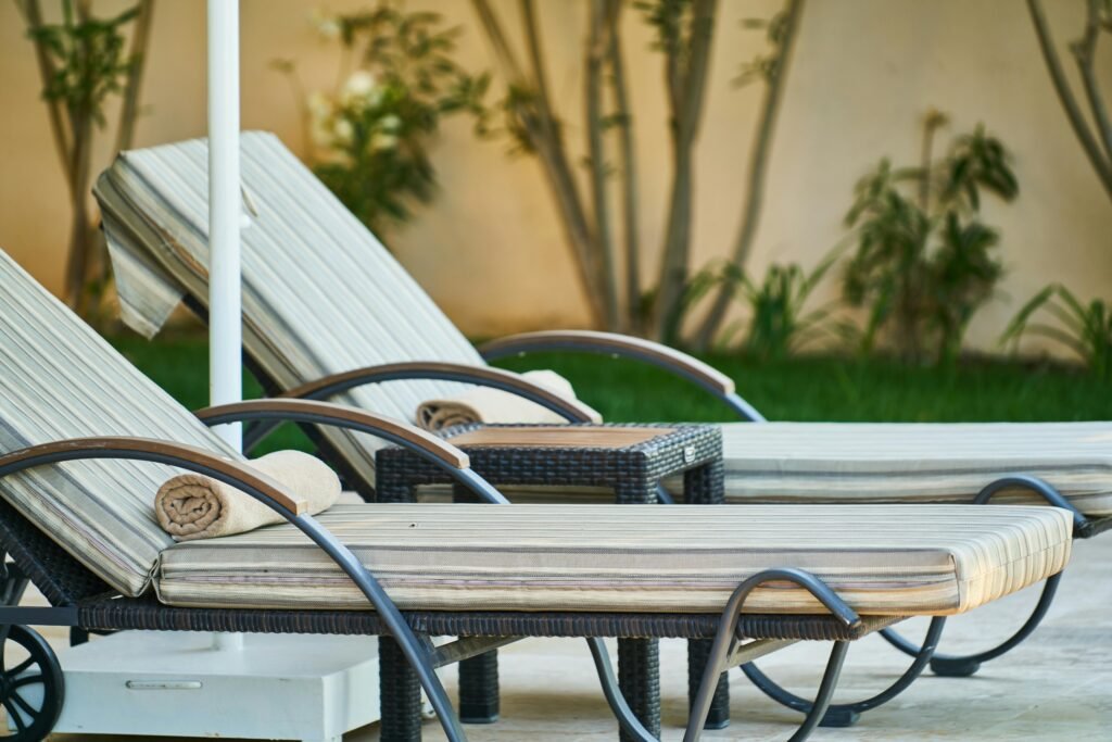 pexels-photo-2771923-2771923 Elegant wooden sun loungers lined up poolside at a tropical resort, perfect for relaxation.