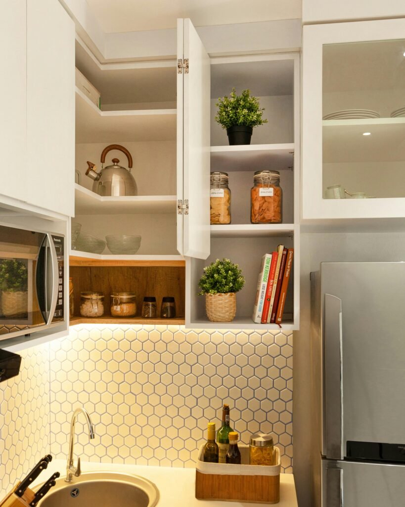 Stylish kitchen interior with open shelves, plants, and utensils.