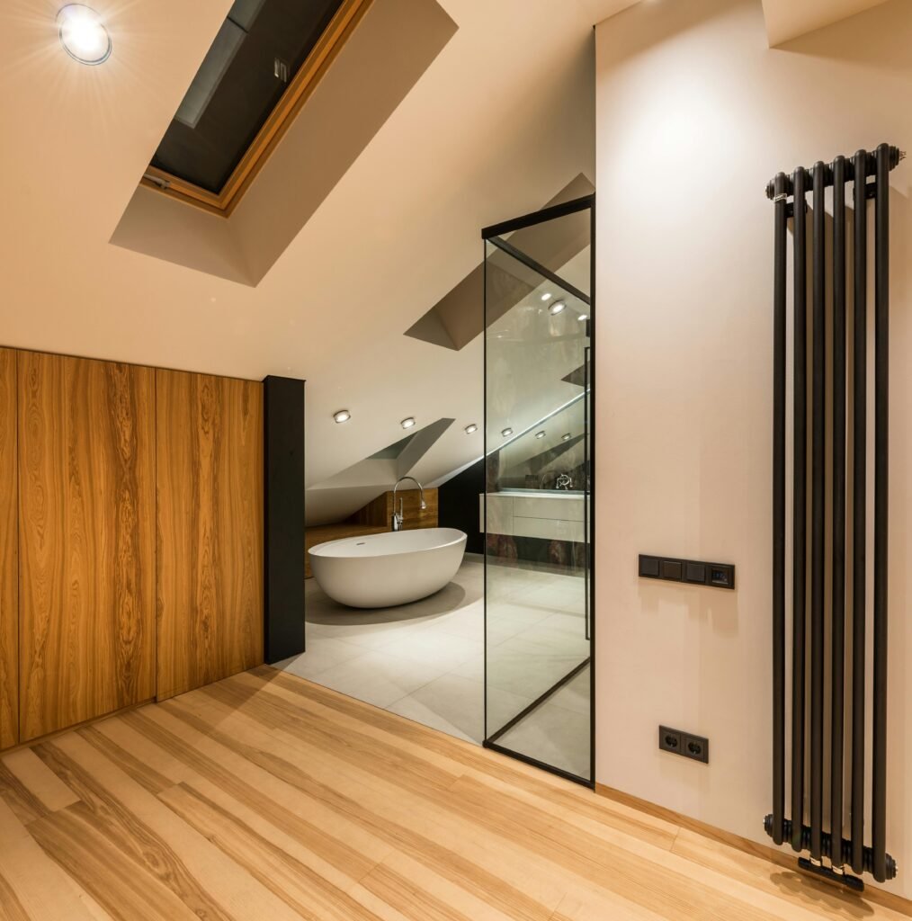 pexels-photo-6032424-6032424 Interior of modern bathroom with wooden elements near entrance and bright illumination over bathtub