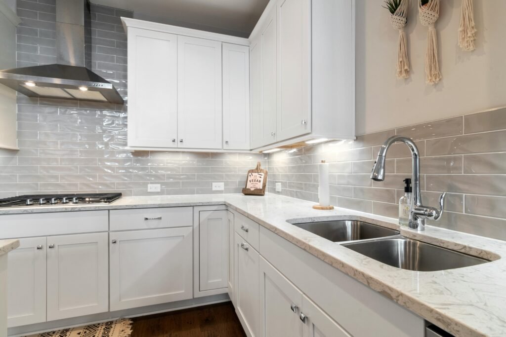 Sleek white minimalist kitchen with marble countertops Sleek white minimalist kitchen with marble countertops and modern fixtures.