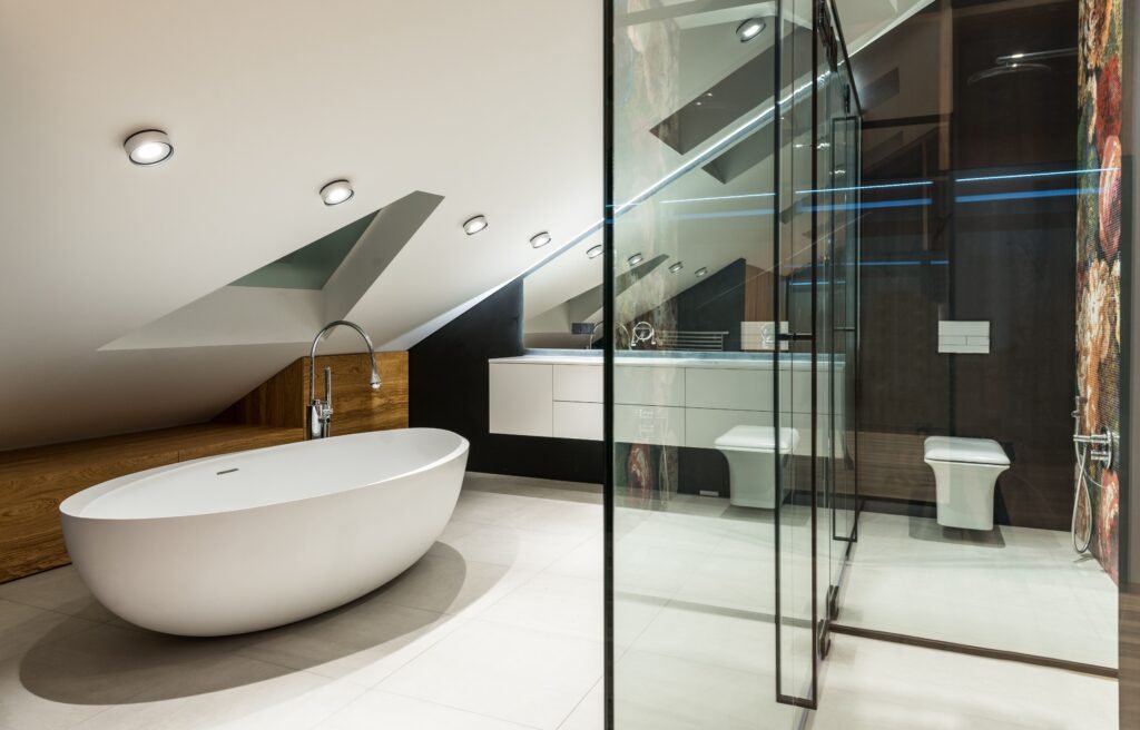 pexels-photo-7045310-7045310 Creative design of bathroom with bath against shower cabin with glass wall on tiled floor in attic