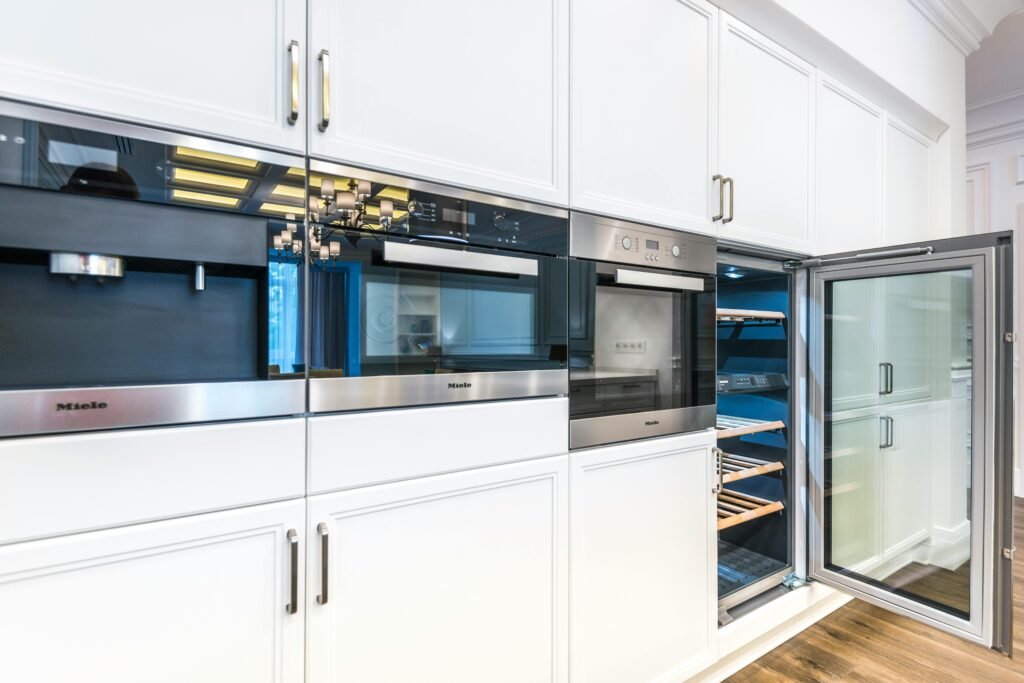 A sleek contemporary kitchen featuring built-in appliances and minimalist white cabinets A sleek contemporary kitchen featuring built-in appliances and minimalist white cabinets for a spacious look.