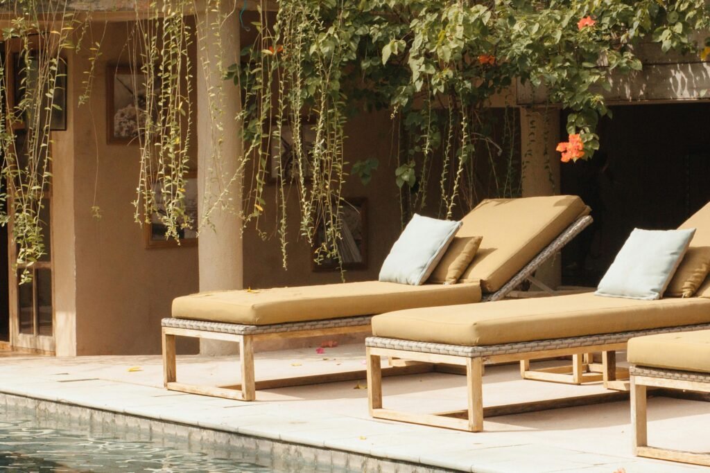 Relax by the pool on stylish sun loungers in a serene resort setting.